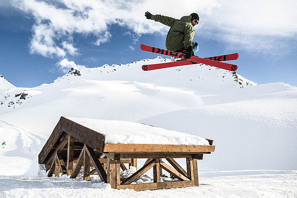 Skier jumps over drop