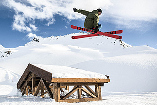 Skier jumps over drop