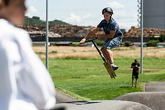 Child jumping with his scooter